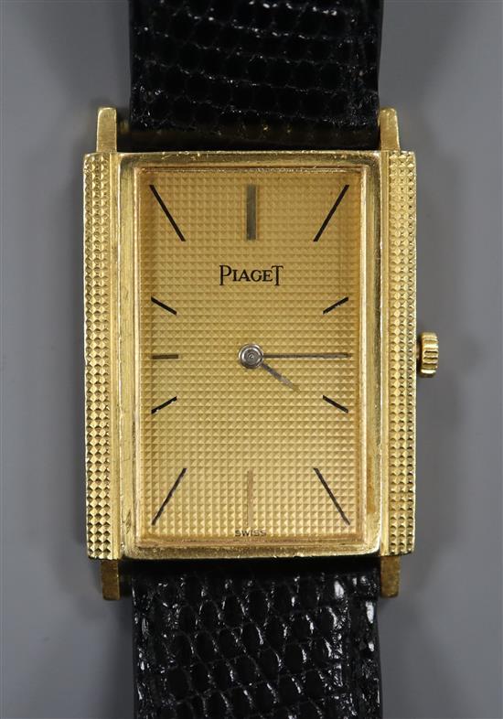 An 18ct gold Piaget rectangular dial manual wind wrist watch, on associated leather strap.